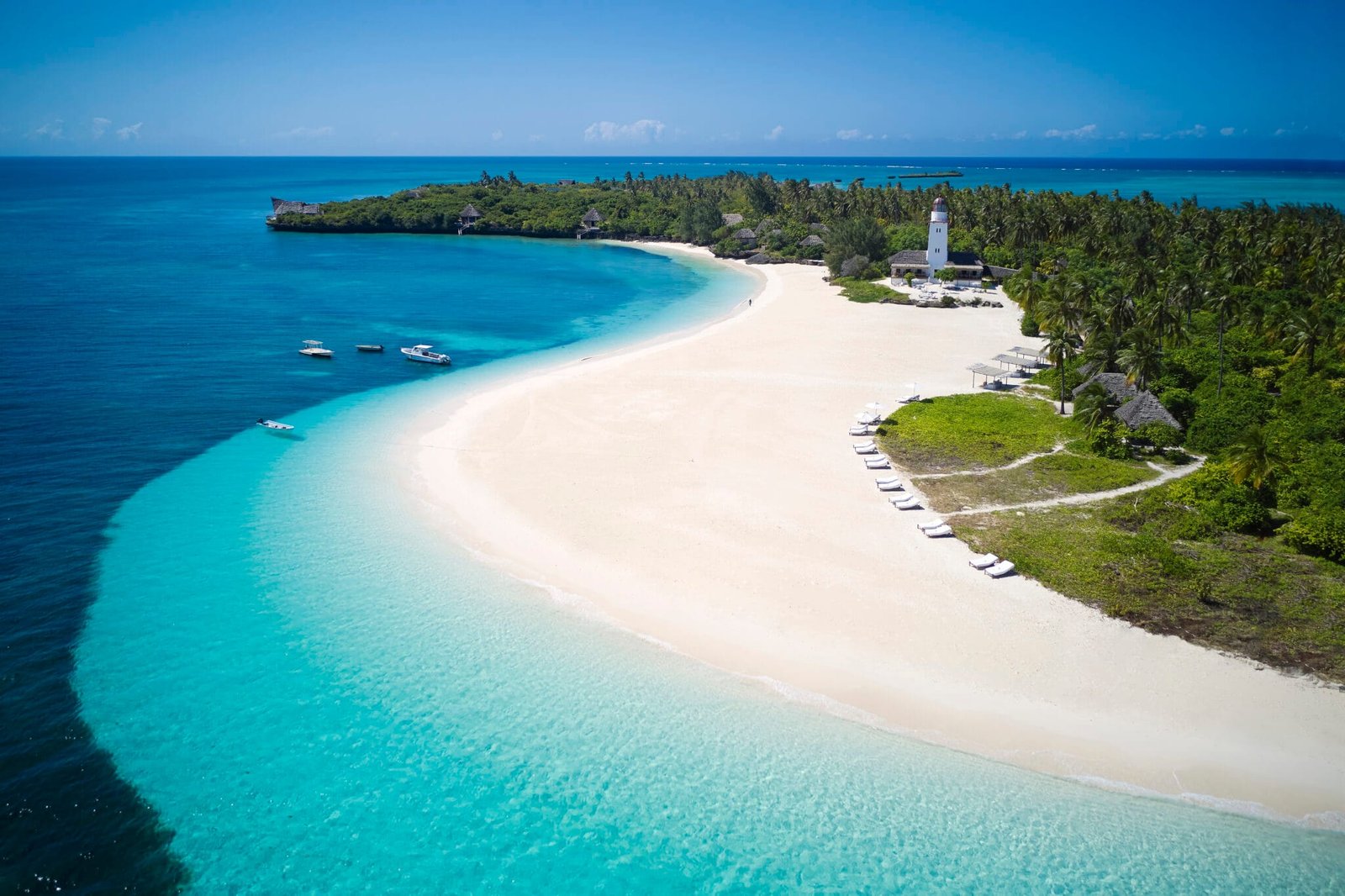 Stunning high aerial view of the narrow private white sandbar and emerald lagoon extending from Fanjove Island