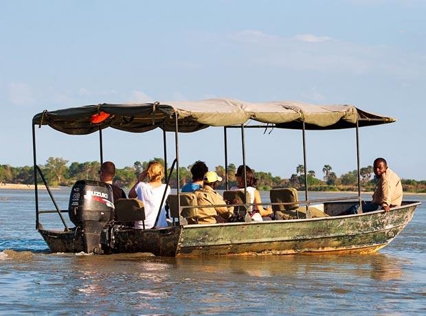 Authentic boat safari exploring the Rufiji River banks in Nyerere National Park at sunset