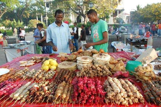 Seafood night market stalls cooking outdoors at Forodhani Gardens in Zanzibar